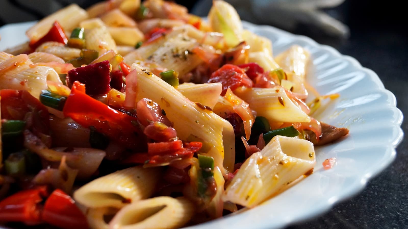 Colourful pasta with fresh vegetables served on a plate